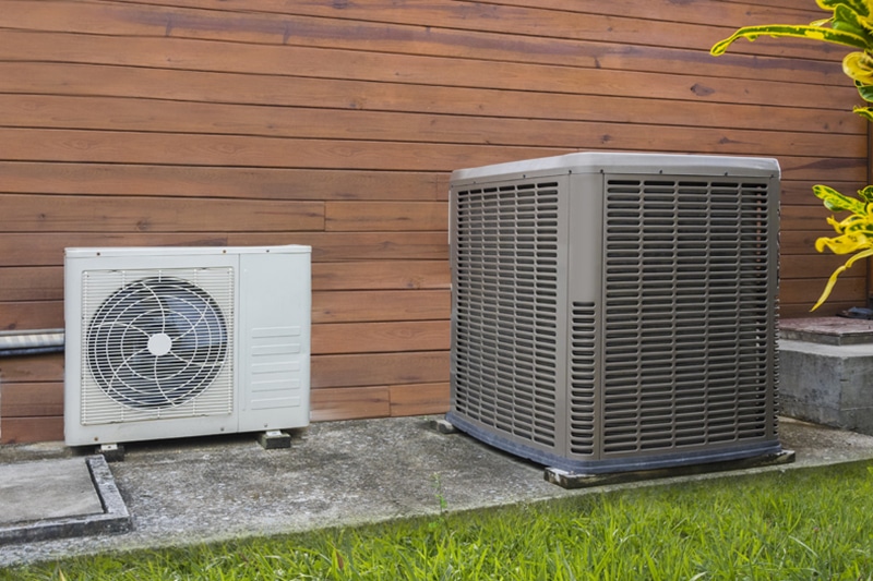 Air conditioning heat pumps on the side of a house.